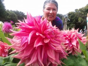 Deborah Dietz in garden with giant dahlia